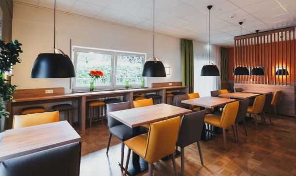 Eleganter Sitzbereich am Buffet mit einer Vase mit Blumen auf der Fensterbank.
